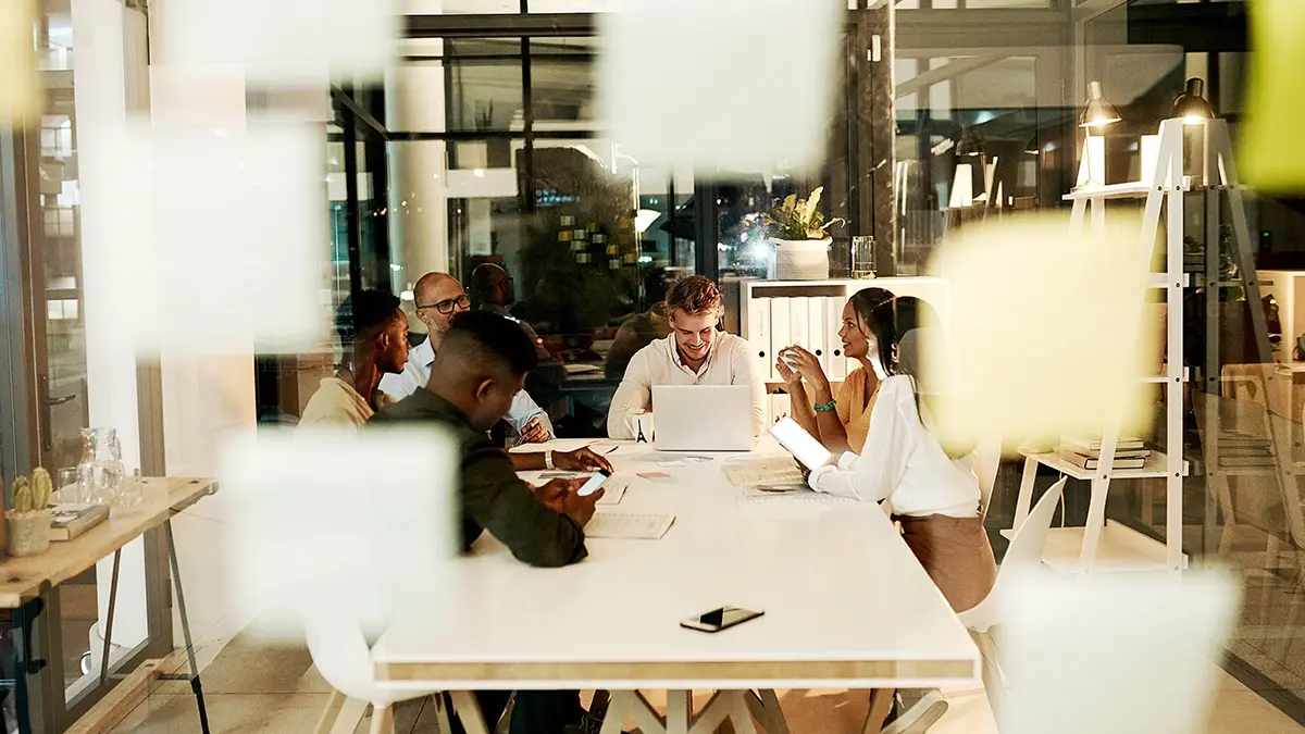 marketing agency team meeting sitting around table