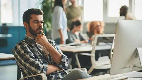 serious bearded guy leaning back in chair contemplating a decision about link building