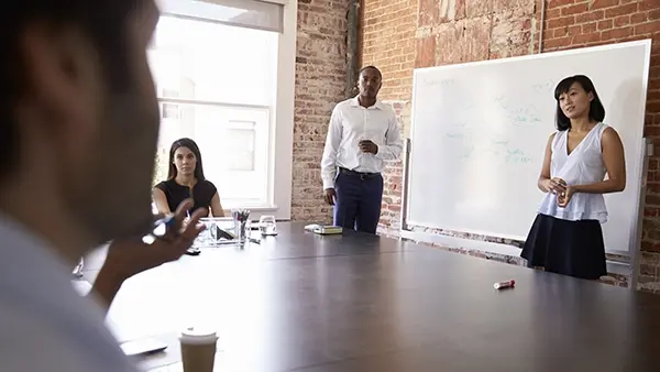 strategy business people at whiteboard giving presentation